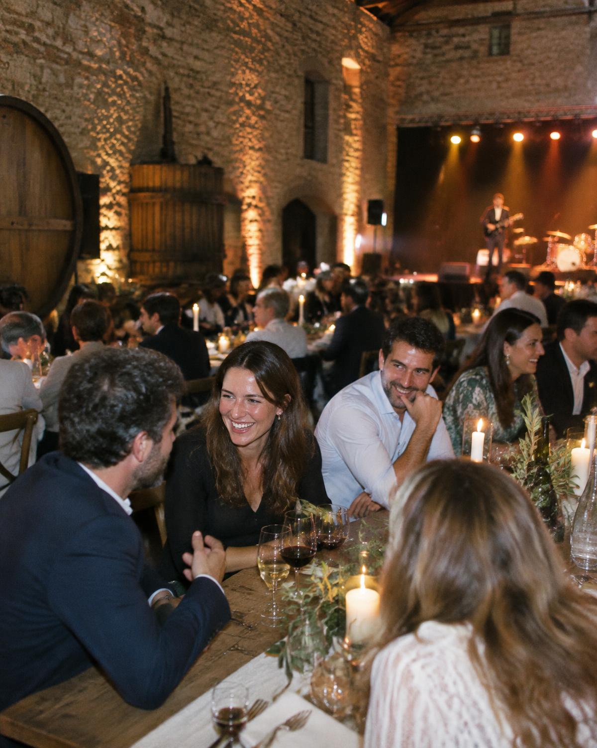 A corporate gala dinner in a dramatic dark venue with stage lighting